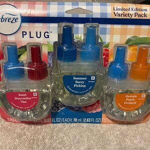 Febreze Plug Scented Oil Refills in Red, Blue, and Orange